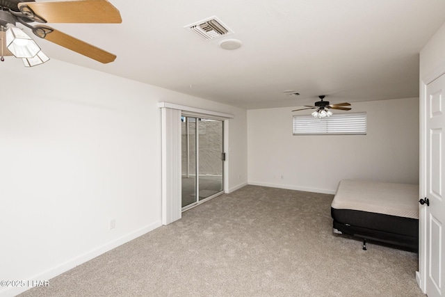 unfurnished bedroom with visible vents, access to exterior, carpet, baseboards, and ceiling fan