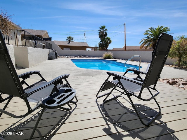 view of swimming pool with a fenced backyard, a fenced in pool, and a wooden deck