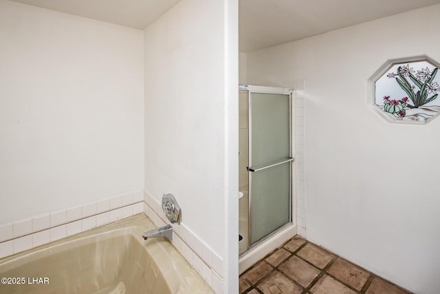 bathroom featuring a bath and a stall shower