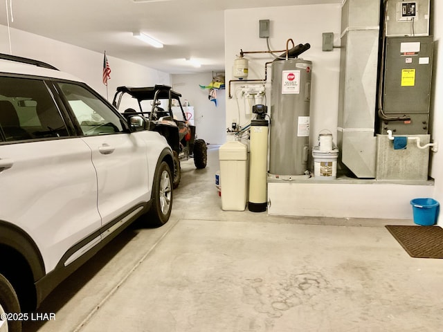 garage featuring heating unit and water heater