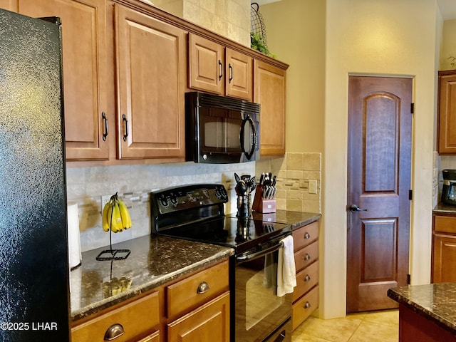 kitchen featuring dark stone countertops, tasteful backsplash, black appliances, and brown cabinetry