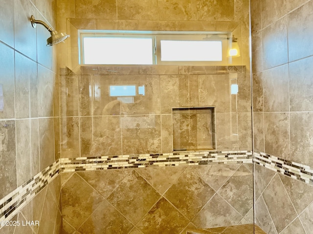 full bath with a tile shower