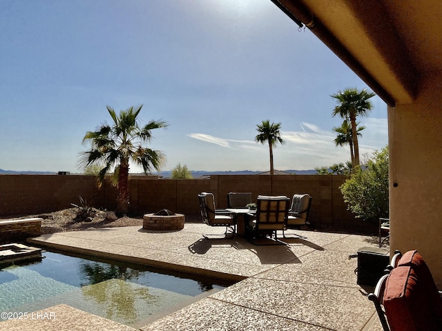 view of patio with an outdoor fire pit and a fenced backyard