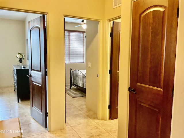 corridor featuring light tile patterned floors and visible vents