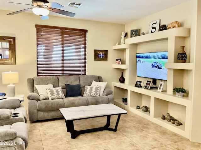 tiled living area with visible vents, a ceiling fan, and built in features