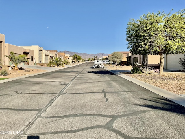 view of road with a residential view and a mountain view