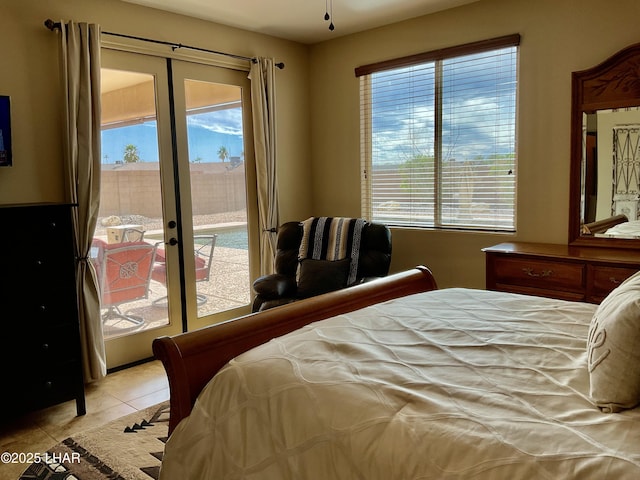 bedroom with access to exterior, light tile patterned floors, and french doors