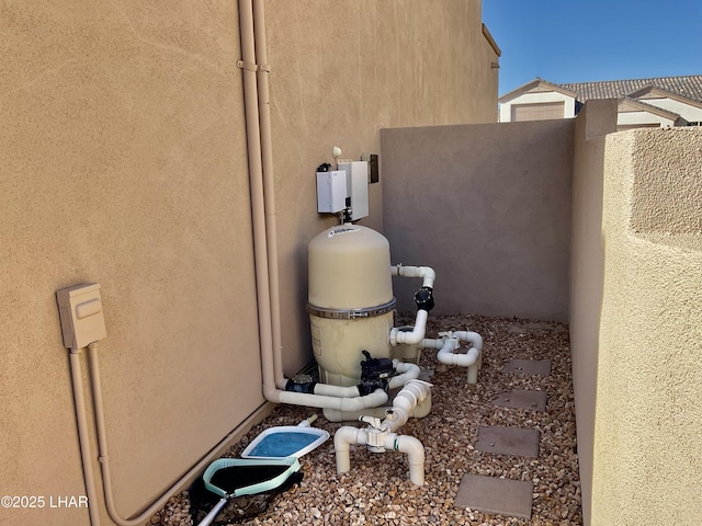 exterior details with stucco siding and pump