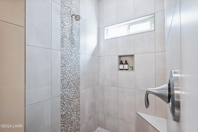 bathroom with tiled shower