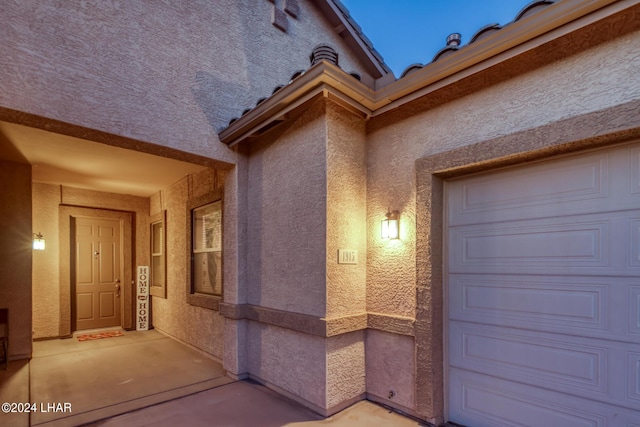 view of exterior entry featuring a garage