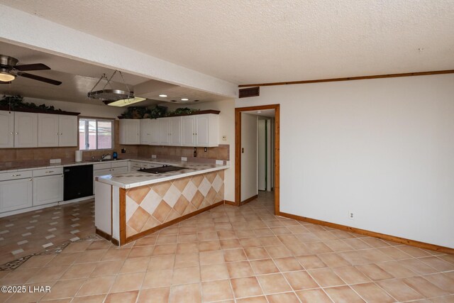 1116 W 4th St, Parker, AZ 85344 - kitchen with black appliances, tile counters, decorative backsplash, white cabinetry, and a peninsula
