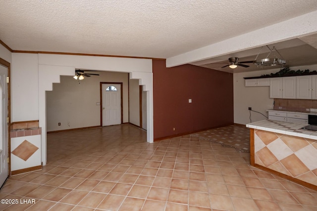 1116 W 4th St, Parker, AZ 85344 - kitchen featuring a ceiling fan, tile countertops, white cabinetry, and a textured ceiling