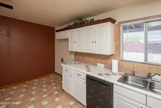 1116 W 4th St, Parker, AZ 85344 - kitchen with dishwasher, tile counters, white cabinetry, and backsplash