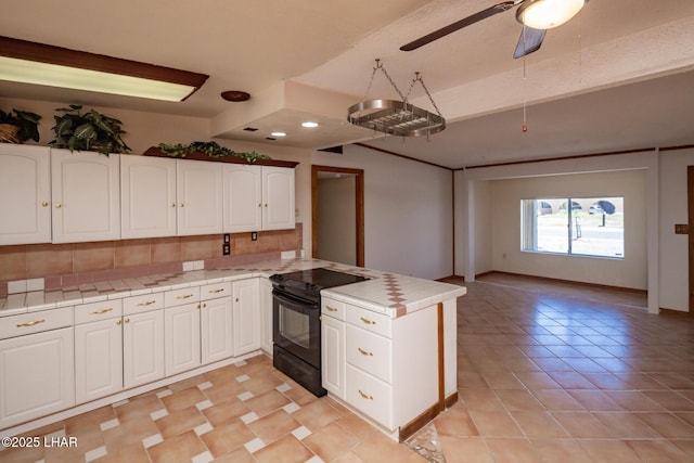 1116 W 4th St, Parker, AZ 85344 - kitchen featuring black range with electric cooktop, a peninsula, white cabinetry, ceiling fan, and light tile patterned floors