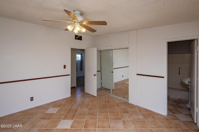 1116 W 4th St, Parker, AZ 85344 - unfurnished bedroom with a textured ceiling, a closet, ceiling fan, ensuite bathroom, and light tile patterned flooring