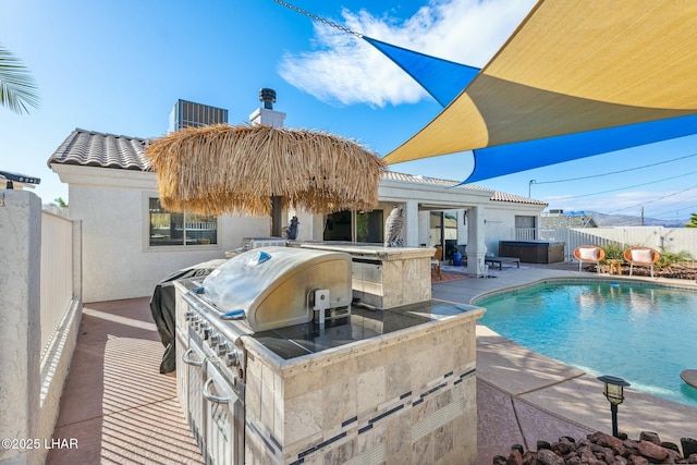 view of pool featuring a patio, a fenced in pool, exterior kitchen, a fenced backyard, and a hot tub