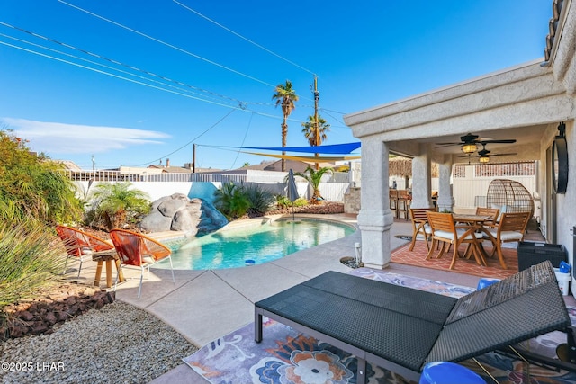 view of swimming pool with ceiling fan, a patio, a fenced backyard, and outdoor dining space