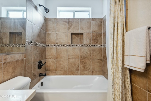 full bathroom featuring plenty of natural light, shower / bath combination with curtain, and toilet