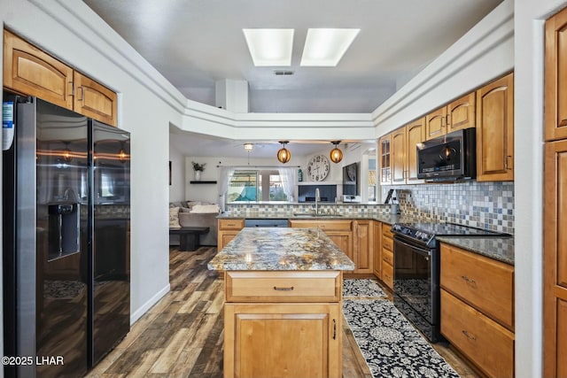 kitchen with a sink, black electric range, stainless steel microwave, refrigerator with ice dispenser, and tasteful backsplash