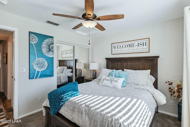 bedroom with a closet, visible vents, baseboards, and dark colored carpet