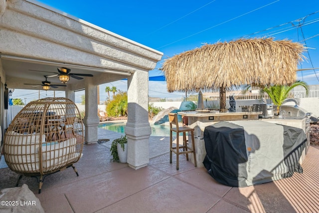 view of patio with a fenced in pool, fence, outdoor wet bar, area for grilling, and ceiling fan