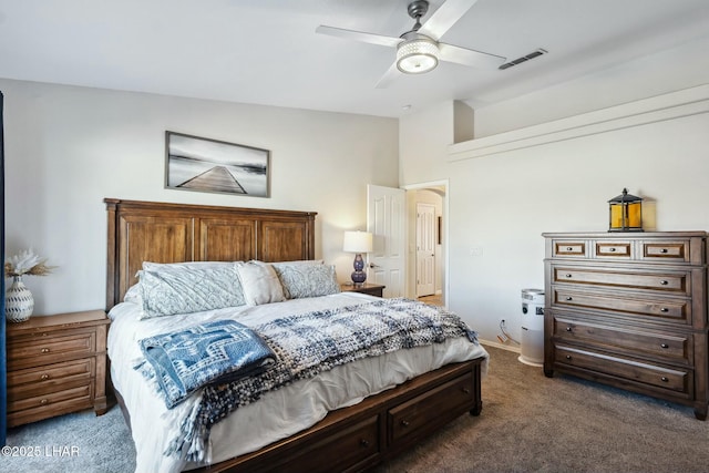 carpeted bedroom with lofted ceiling, visible vents, and ceiling fan