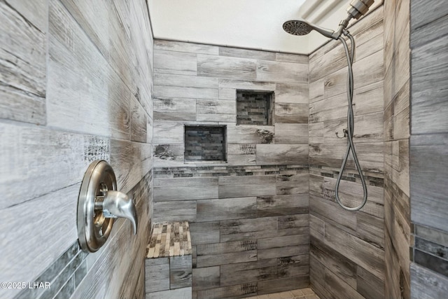 bathroom with tiled shower