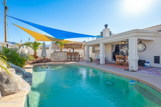 view of pool featuring a fenced in pool, a patio area, fence, and outdoor dry bar