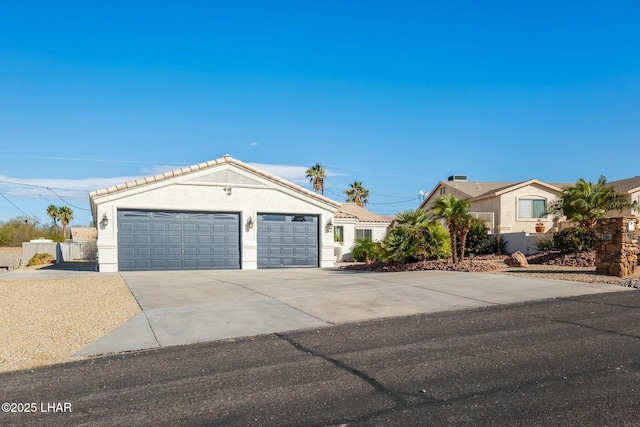 ranch-style home featuring stucco siding, driveway, an attached garage, and fence