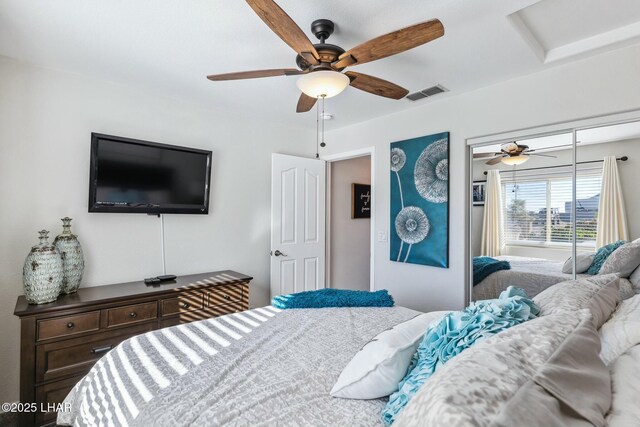 bedroom with a closet, visible vents, and a ceiling fan