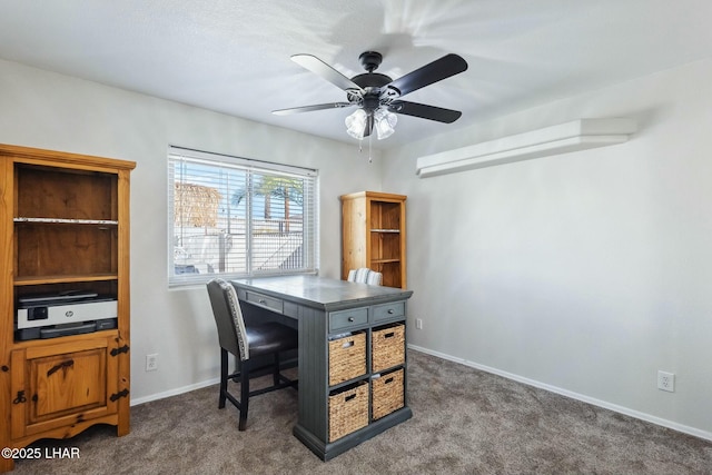 carpeted home office with baseboards and ceiling fan