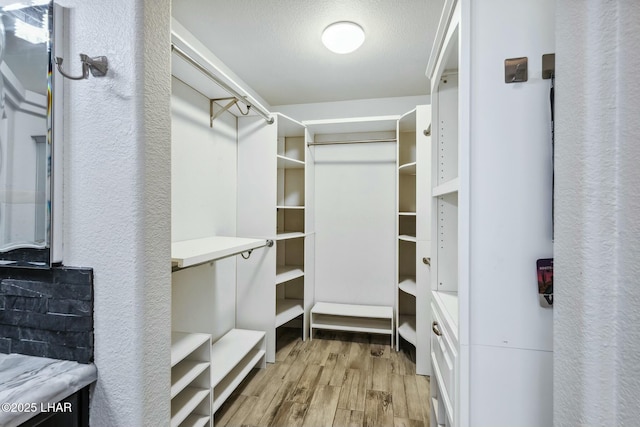 spacious closet featuring wood finished floors