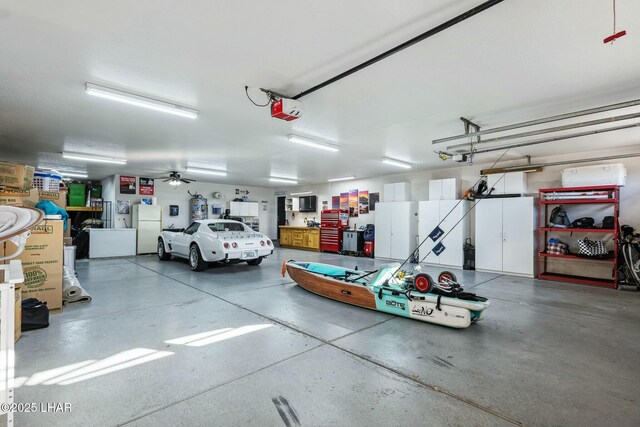 garage featuring a garage door opener and freestanding refrigerator