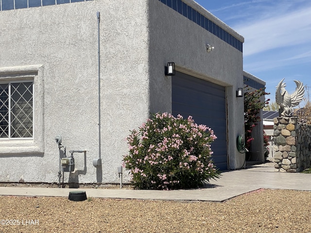 211 Columbine Dr, Lake Havasu City, AZ 86403 - view of side of property with a garage and stucco siding