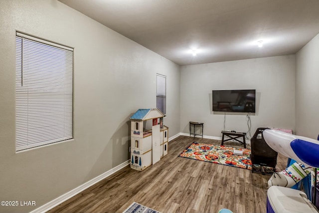 living area featuring wood finished floors and baseboards