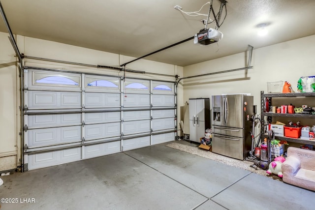 garage with a garage door opener and stainless steel fridge