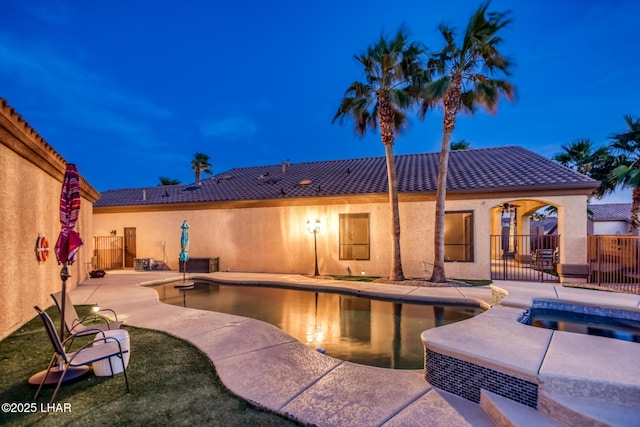 view of swimming pool with a fenced in pool, a patio area, a fenced backyard, and an in ground hot tub