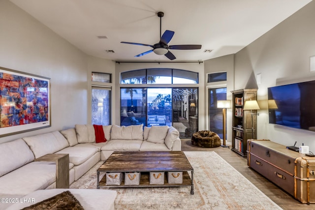 living area with ceiling fan, wood finished floors, and visible vents