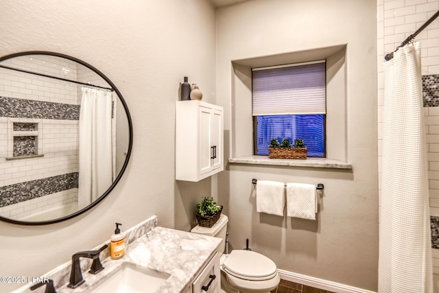 bathroom with baseboards, vanity, toilet, and a shower with curtain