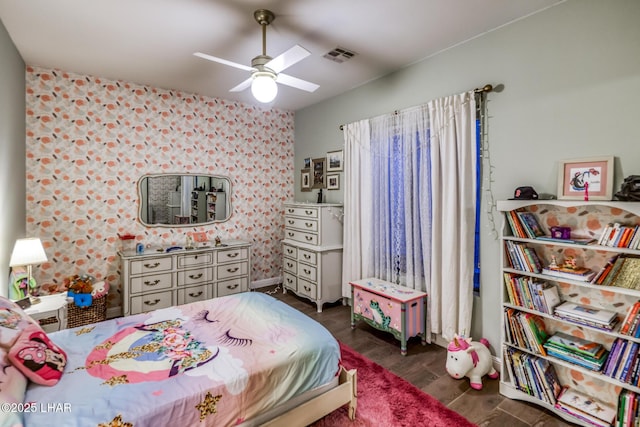 bedroom featuring visible vents, ceiling fan, and wood finished floors