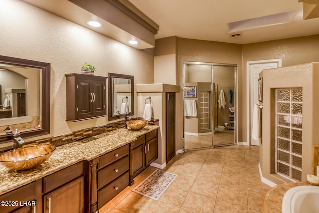 bathroom featuring double vanity, recessed lighting, visible vents, a sink, and tile patterned floors