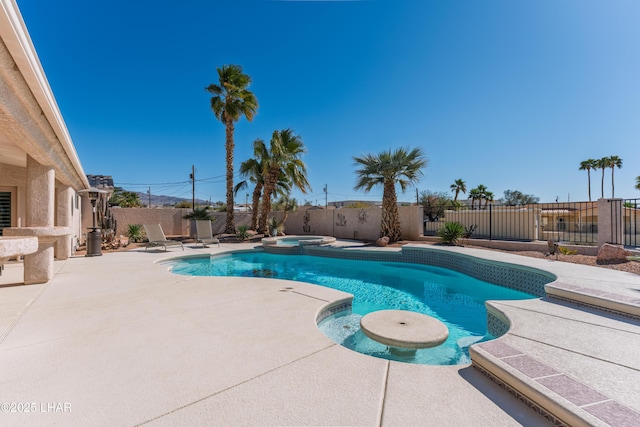 view of pool with a patio, a fenced backyard, and a pool with connected hot tub