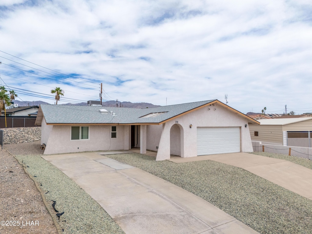 20 Lightning Ln, Lake Havasu City, AZ 86403 - ranch-style house with driveway, stucco siding, fence, a garage, and solar panels