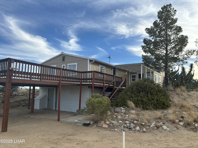 rear view of property featuring a wooden deck