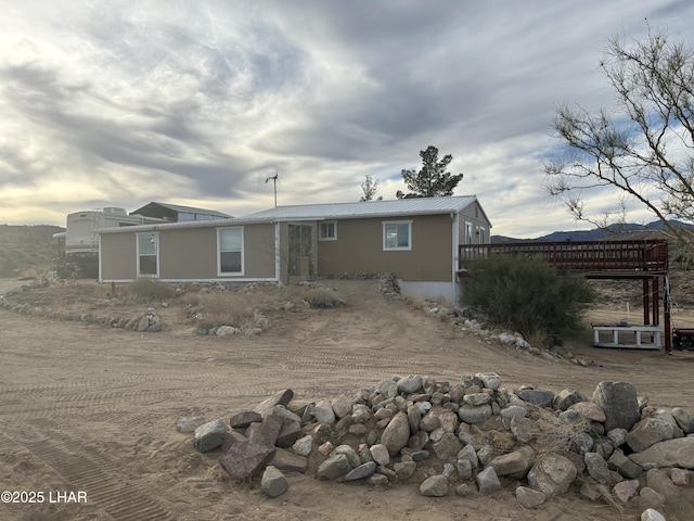 back of house with metal roof