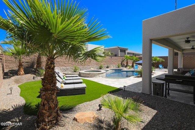 view of yard with a fenced backyard, a ceiling fan, a patio, an in ground hot tub, and a fenced in pool