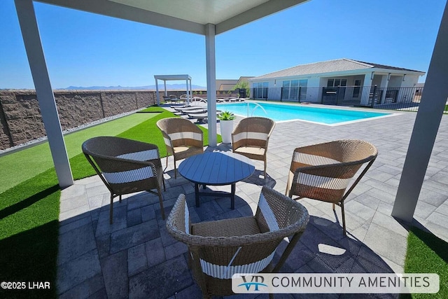 view of pool with a fenced in pool, a patio, and fence