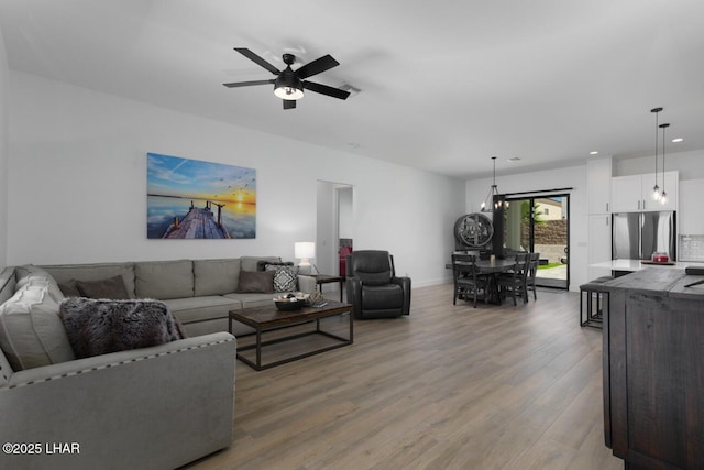 living area with wood finished floors, baseboards, a ceiling fan, and recessed lighting