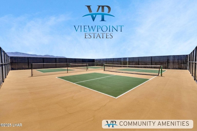 view of tennis court featuring fence