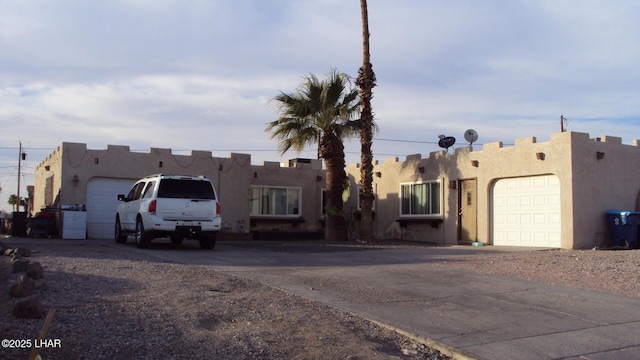 southwest-style home featuring a garage